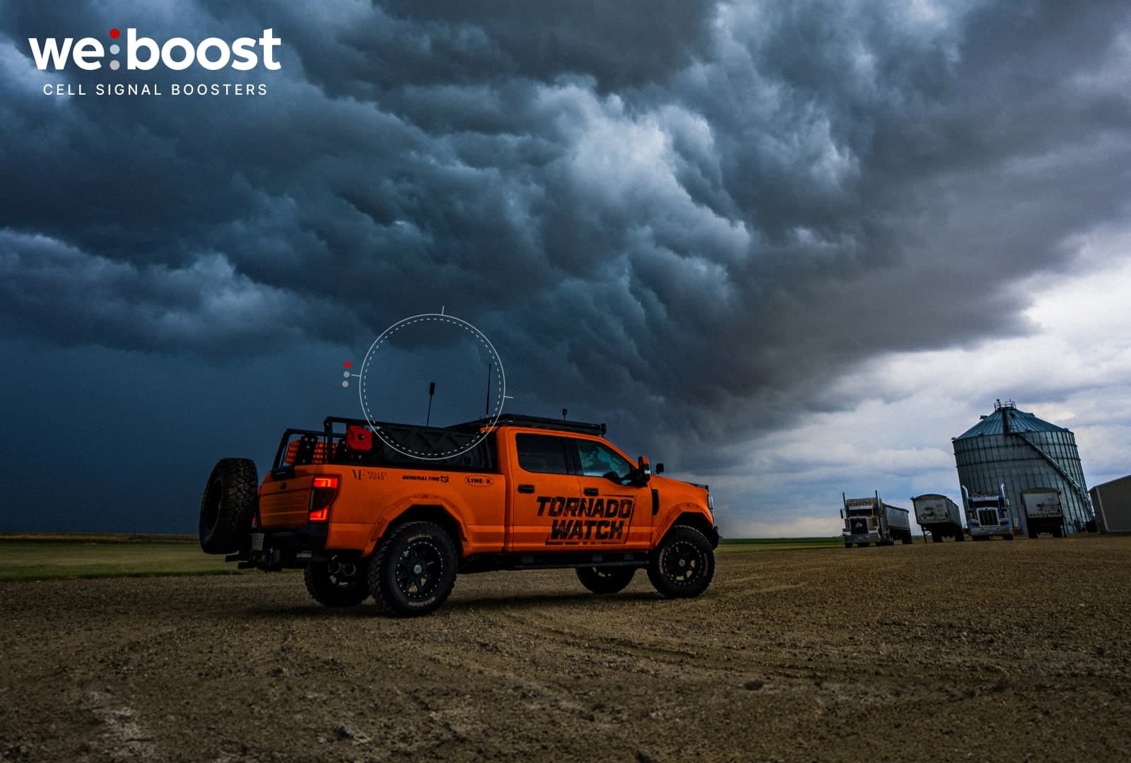 Pickup truck on a farm with clouds in the background