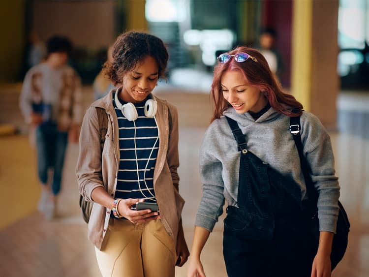 Students using mobile devices supported by school communication systems