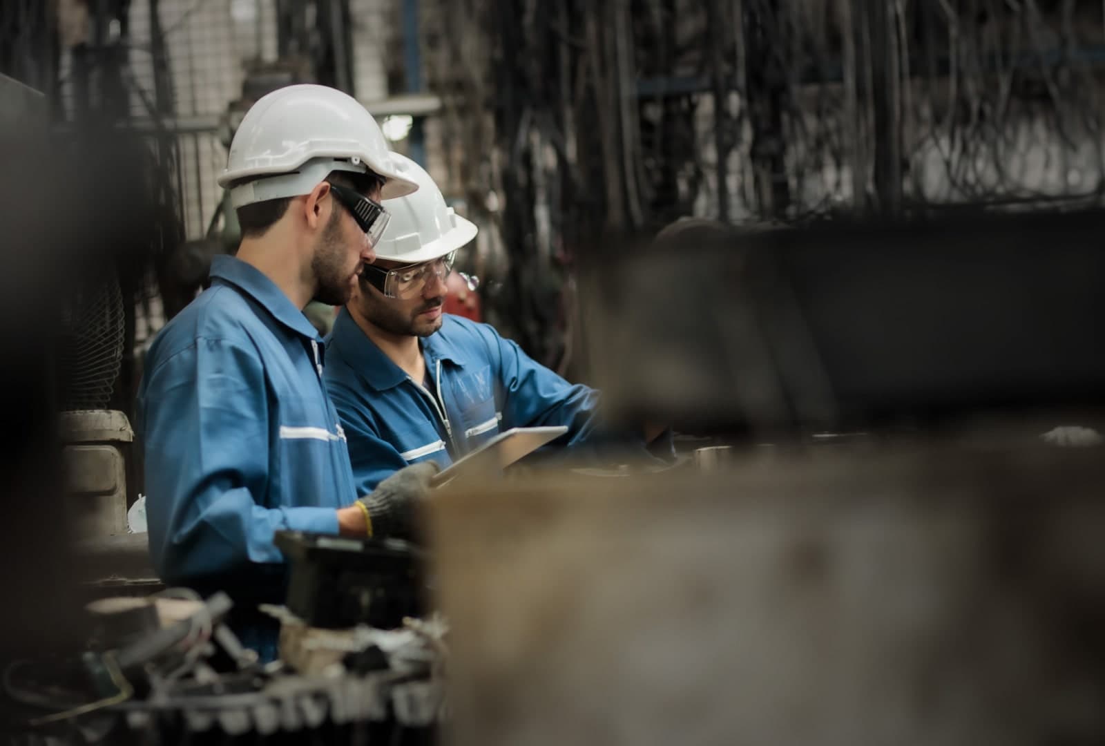 Employees wearing hard hats in a factory